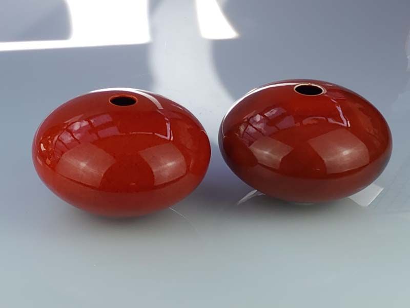 A pair of Peter Collis Red Orb Vases